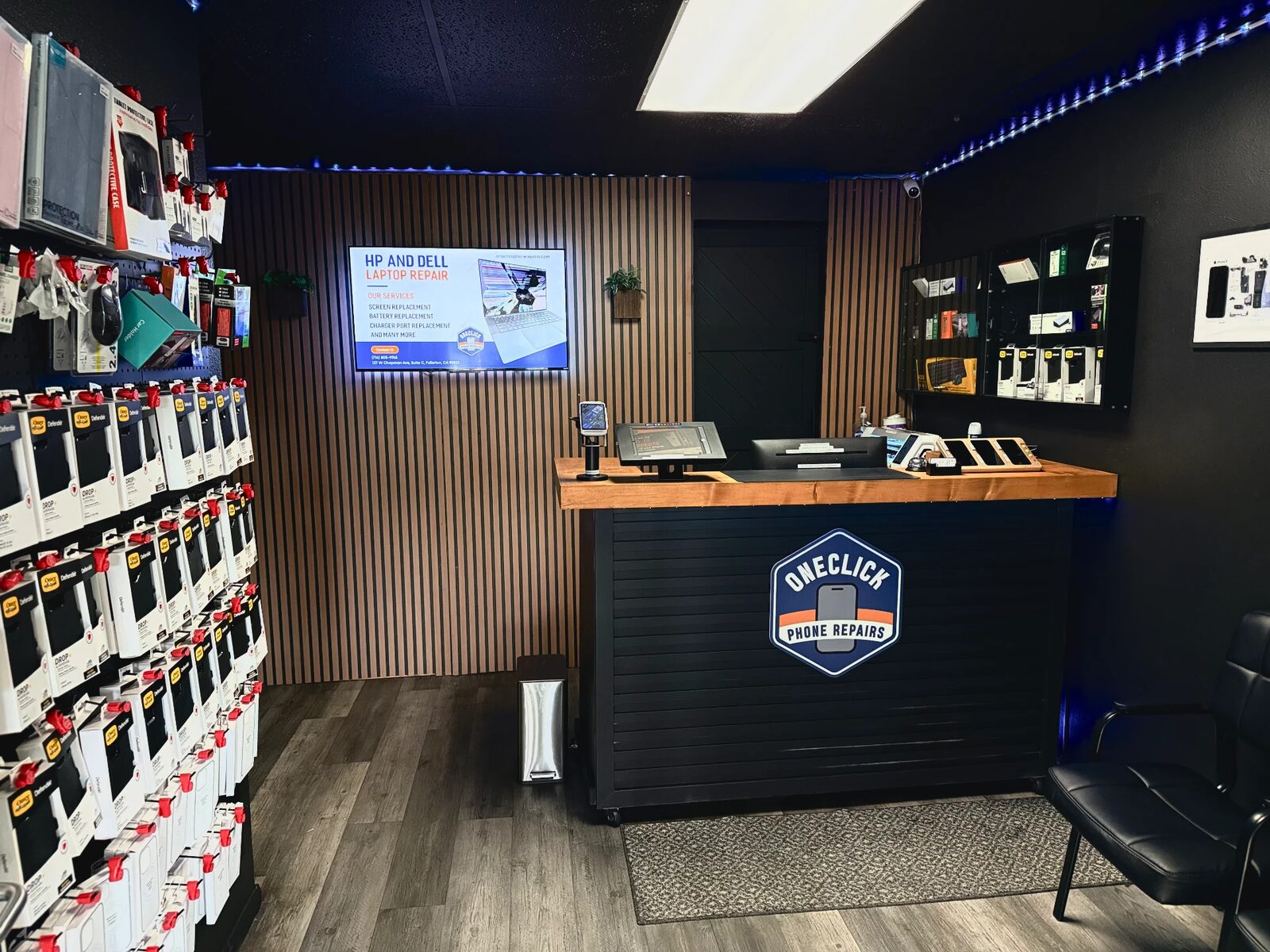 Inside the OneClick Phone Repairs shop in Fullerton, CA — front counter and accessory wall